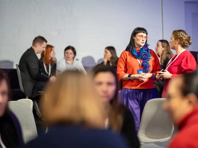 Participants of the sixth Summit for Education talking in small groups, December 2025
