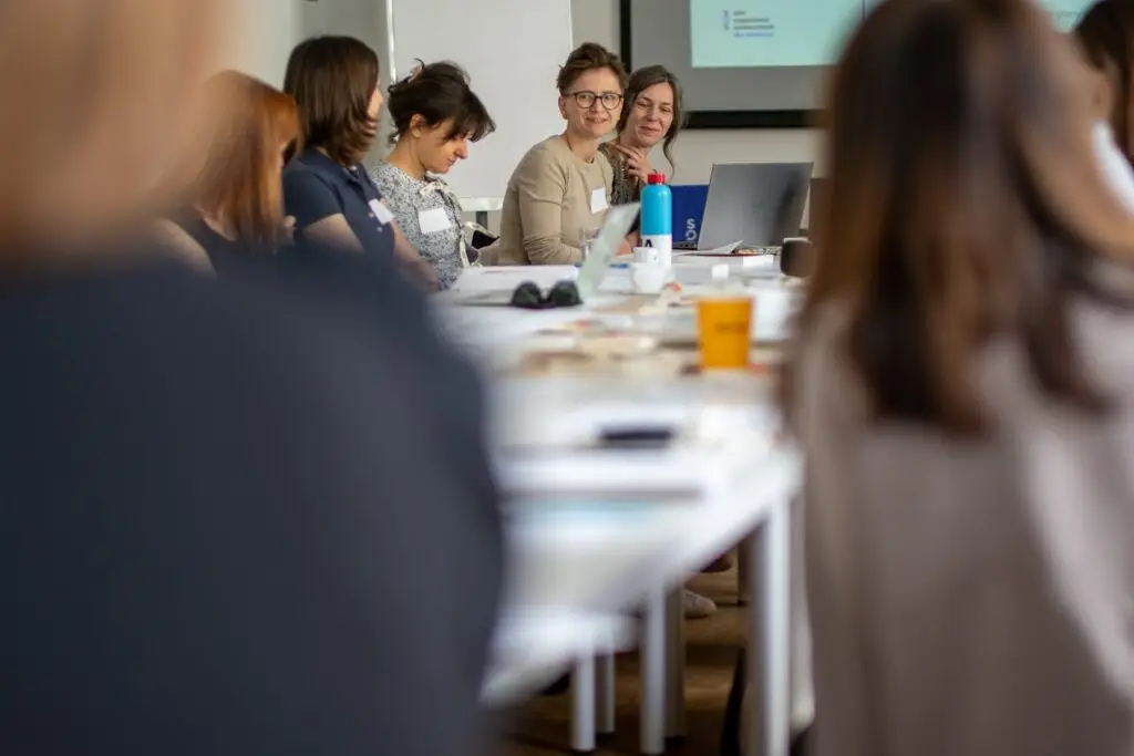 Participants of the Women Leaders for Education programme in discussion at a long table